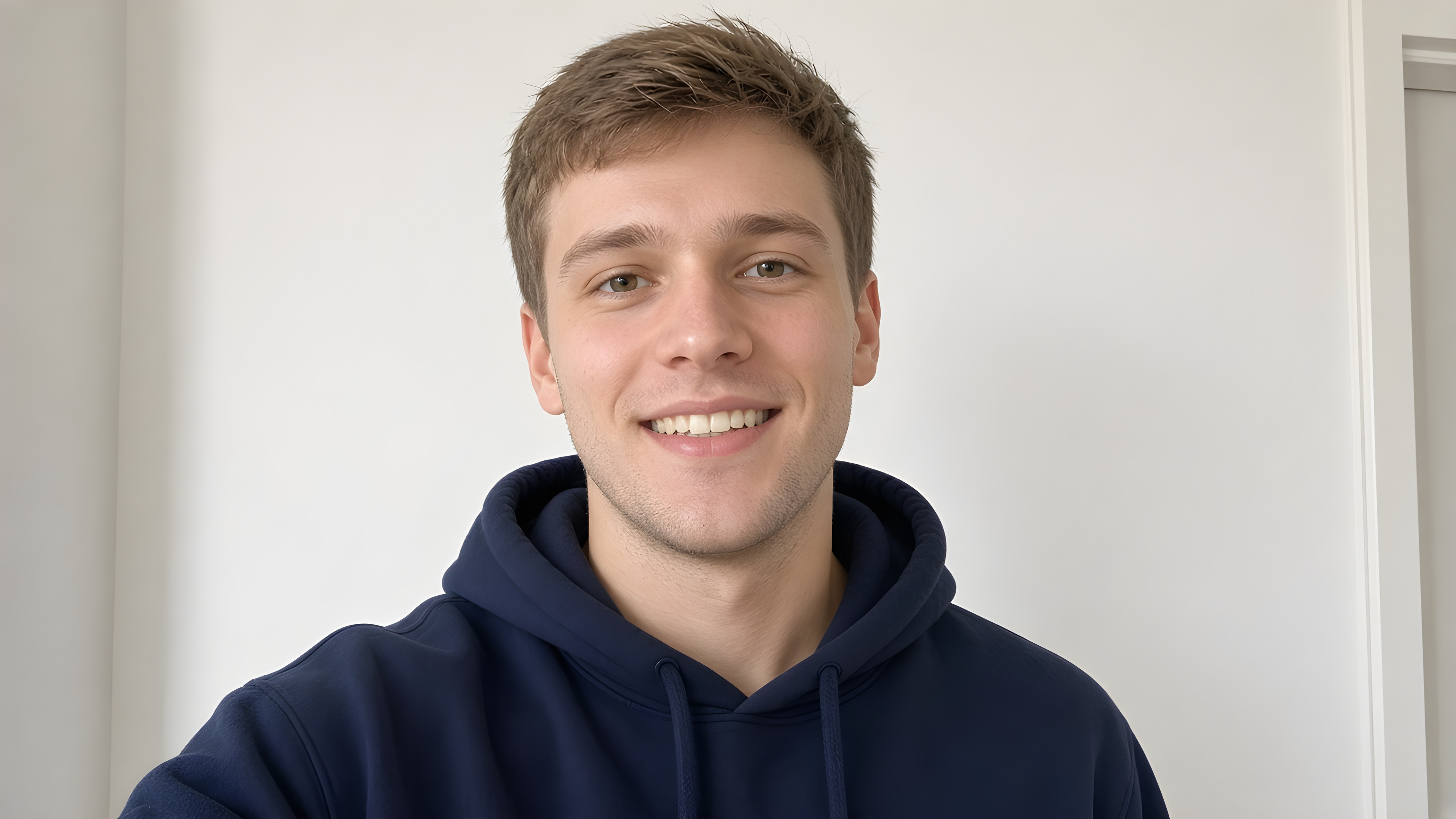 Before: a casual selfie of a man in a navy hoodie (sample)